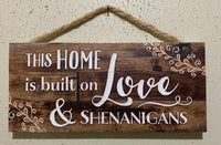 This home is built on love and shenanigans wall plaque